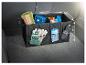 Organisateur de coffre avec des compartiments pour une serviette, une trousse de premiers soins et des gants.