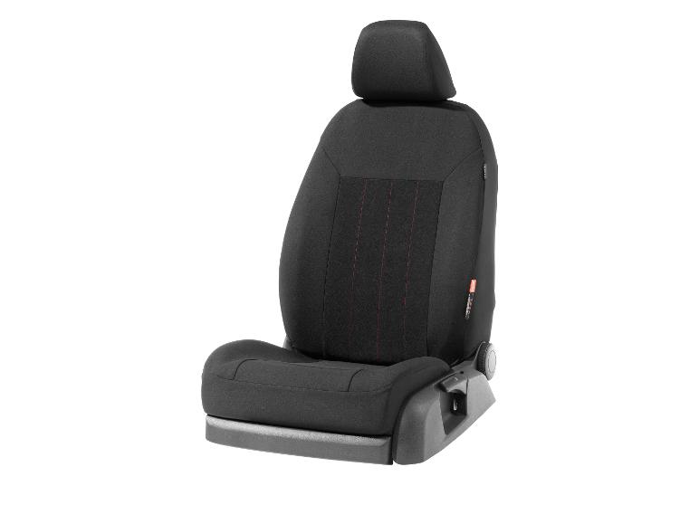 Un siège de voiture noir avec des coutures rouges.