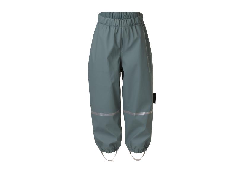 Pantalon imperméable pour enfants avec détails réfléchissants et sangles élastiques aux chevilles.