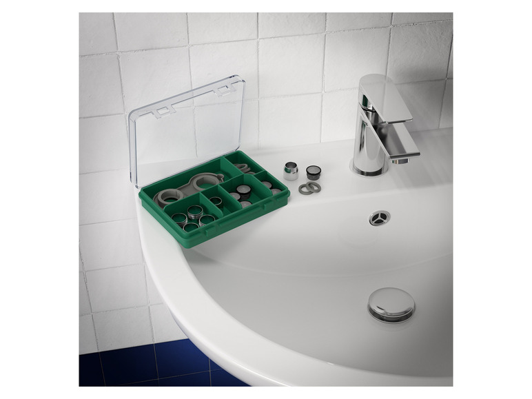 Une boîte verte avec différentes pièces pour un robinet.