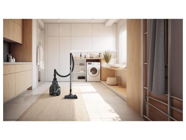 Aspirateur sur un tapis dans une buanderie moderne.