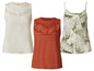 Trois tops pour femmes, un avec de la dentelle blanche, un orange et un avec un imprimé floral vert.