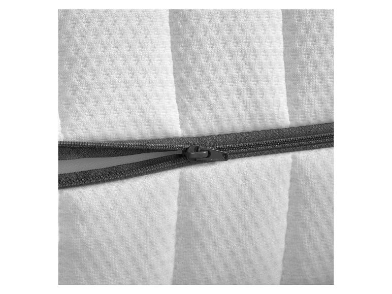 Détail d'une housse de matelas blanche avec fermeture éclair.