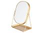 Miroir de maquillage doré avec plateau.