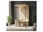 Sauna en bois avec porte vitrée et chauffage, placé dans une pièce moderne avec plantes.