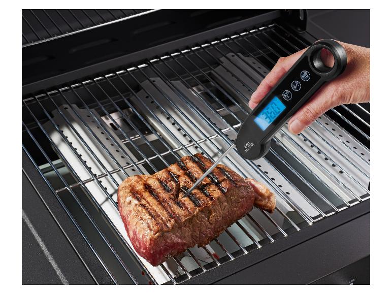 Thermomètre à viande numérique Grill Meister, vérifiant la température d'un steak sur le gril.