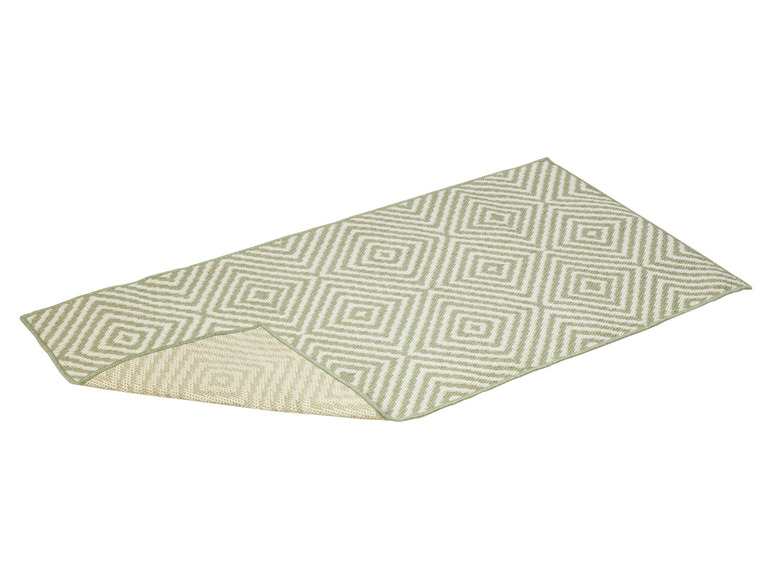Un tapis vert avec un motif géométrique