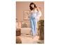 Femme enceinte tenant son ventre, vêtue d'un pantalon de maternité bleu clair et d'un haut blanc.