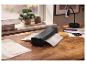 Plastifieuse TRONIC sur un bureau en bois en train de plastifier une feuille de papier.