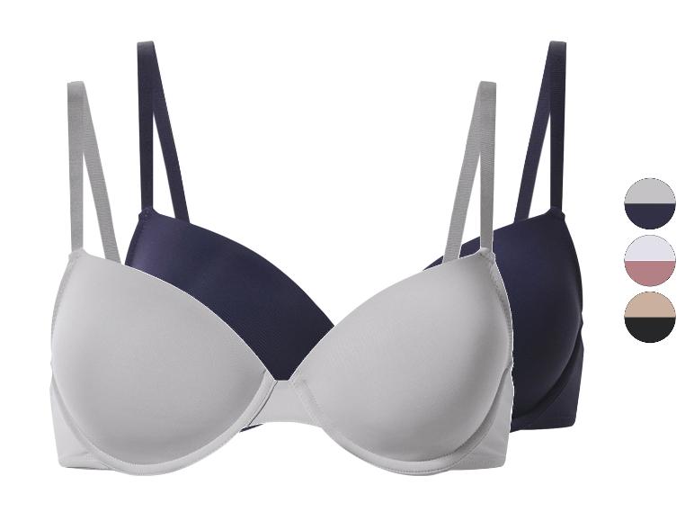 Deux soutiens-gorge en blanc et bleu marine avec des palettes de couleurs assorties.