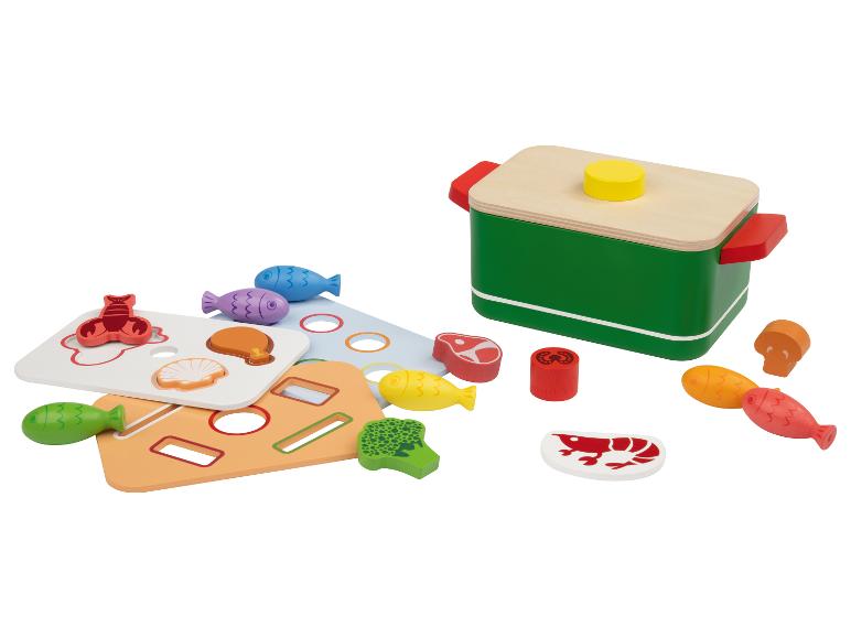 Ensemble de jeu en bois avec une marmite et des aliments, dont poisson, viande et légumes.