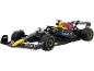 Voiture de course miniature de Formule 1 noire et jaune.