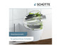 Gros plan sur une cuvette de toilettes blanche avec un couvercle vert et gris de Schütte.