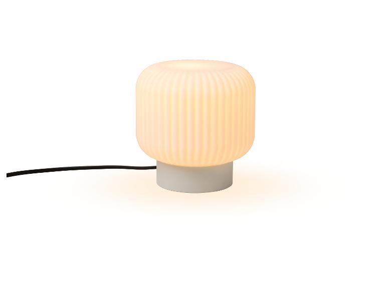Lampe de table avec une base blanche et un abat-jour blanc nervuré.
