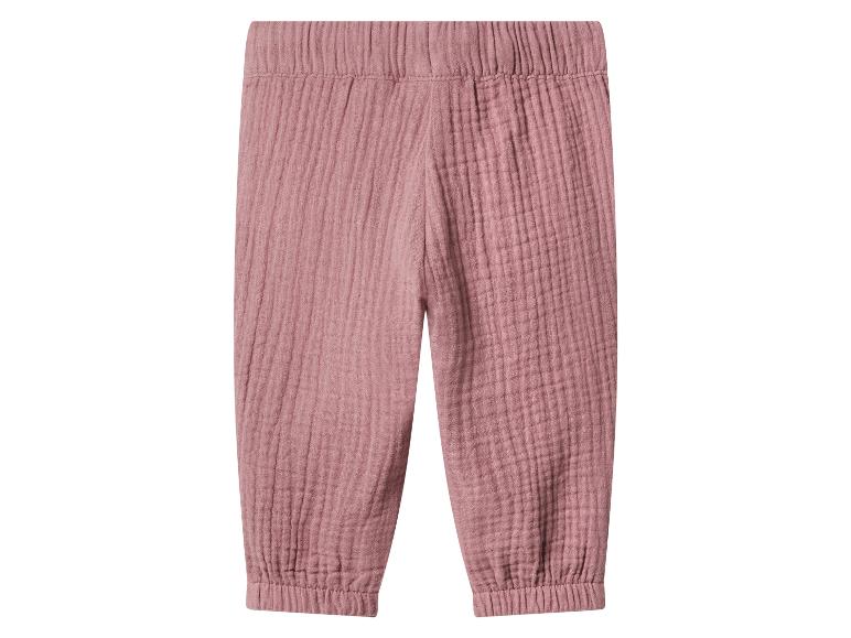 Pantalon en coton froissé rose avec taille et chevilles élastiques.