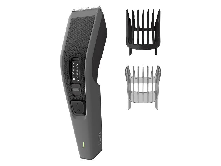 Tondeuse à cheveux avec réglage de la longueur et deux sabots.