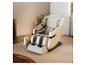 Fauteuil de massage beige et gris dans un salon avec un porte-revues.
