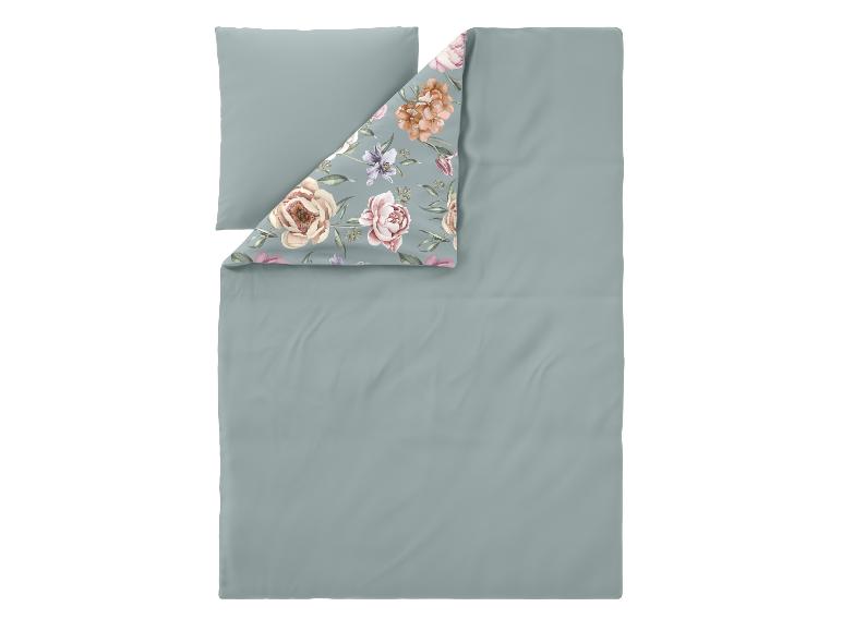 Parure de lit avec une face vert sauge unie et un motif floral au verso.