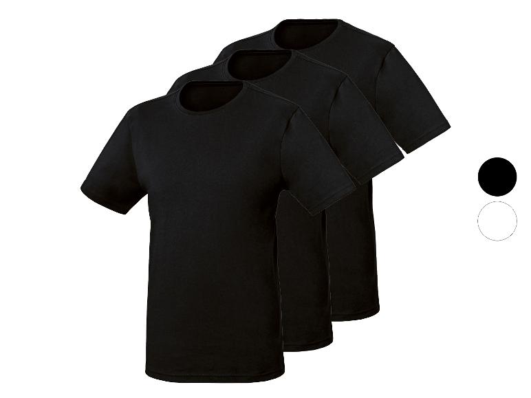 Trois t-shirts noirs à col rond, disposés en diagonale