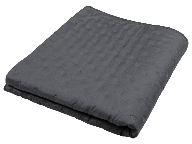 Couverture matelassée gris foncé avec motifs floraux en relief