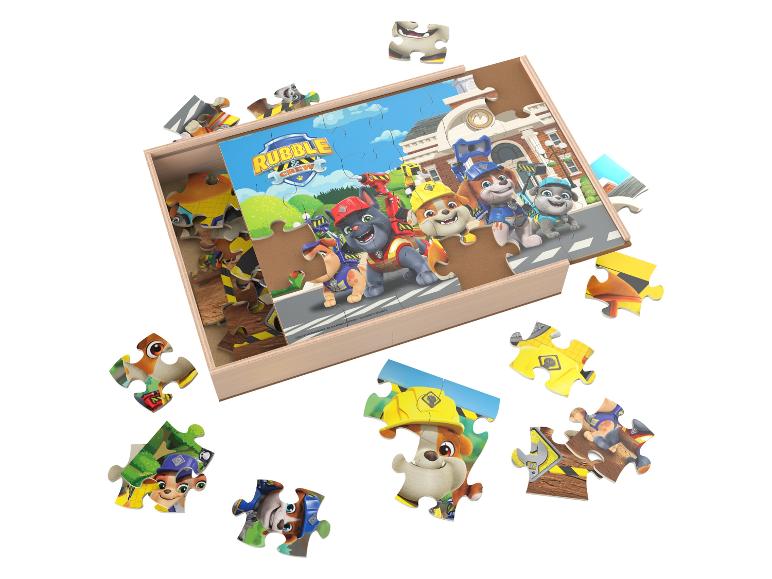 Puzzle en bois avec des chiots et le texte « Rubble & Crew » dans une boîte en bois.