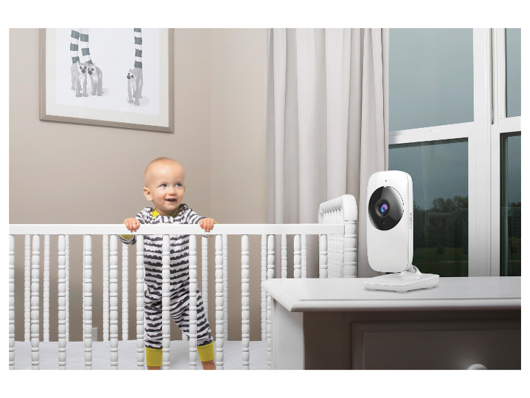 Un bébé dans un berceau et une caméra de surveillance dans une chambre d'enfant.