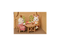 Deux figurines de lapins assises à une table en bois avec un bol de fruits.