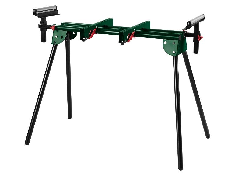 Support de travail vert avec pieds noirs et rouleaux, sur fond blanc.