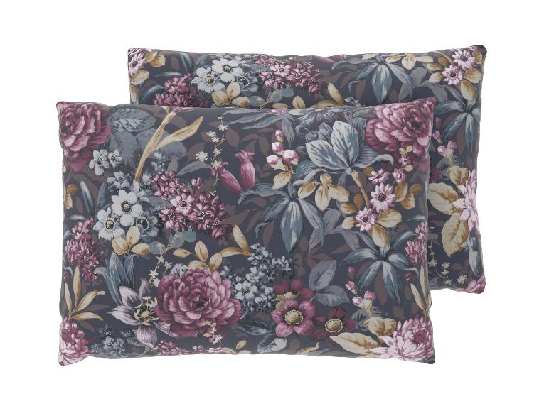 Deux oreillers avec un motif floral foncé présentant des fleurs violettes et blanches et des feuilles bleues.