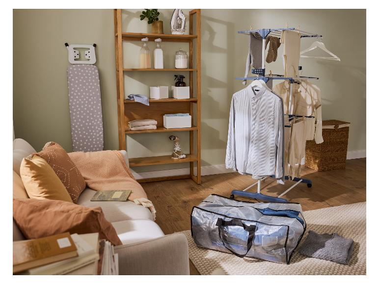 Buanderie avec étendoir à linge, planche à repasser et étagère en bois.