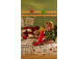 Enfant assis sur un lit décoré pour Noël et jouant avec un perroquet en peluche.