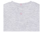 Le dos d'un t-shirt gris avec des boutons roses.