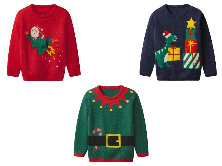 Trois pulls de Noël: un rouge avec le Père Noël sur une fusée, un bleu avec un dinosaure et des cadeaux, un vert d'elfe.