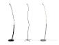 Trois lampadaires LED modernes, un noir et deux argentés, sur fond blanc.
