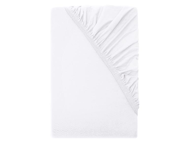 Drap-housse blanc plié avec élastique