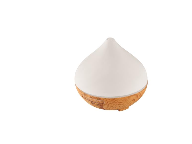 Un humidificateur d'air blanc et rond avec une base en bois.