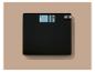 Pèse-personne noir avec affichage numérique indiquant «0.0 kg».