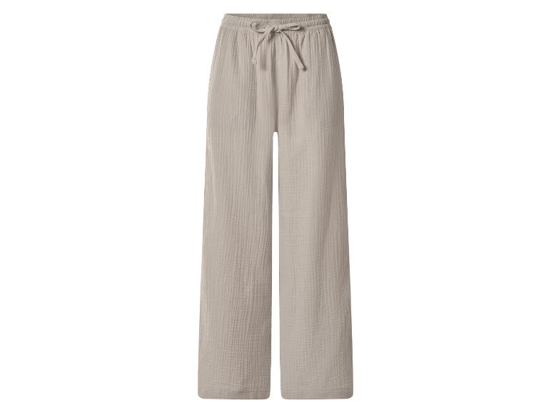 Pantalon large en mousseline beige avec taille élastique et cordon de serrage.