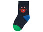 Une chaussette bleu foncé avec un monstre rouge et des accents de couleur.