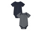 Deux bodys pour bébé : un uni bleu foncé et un à rayures blanches.