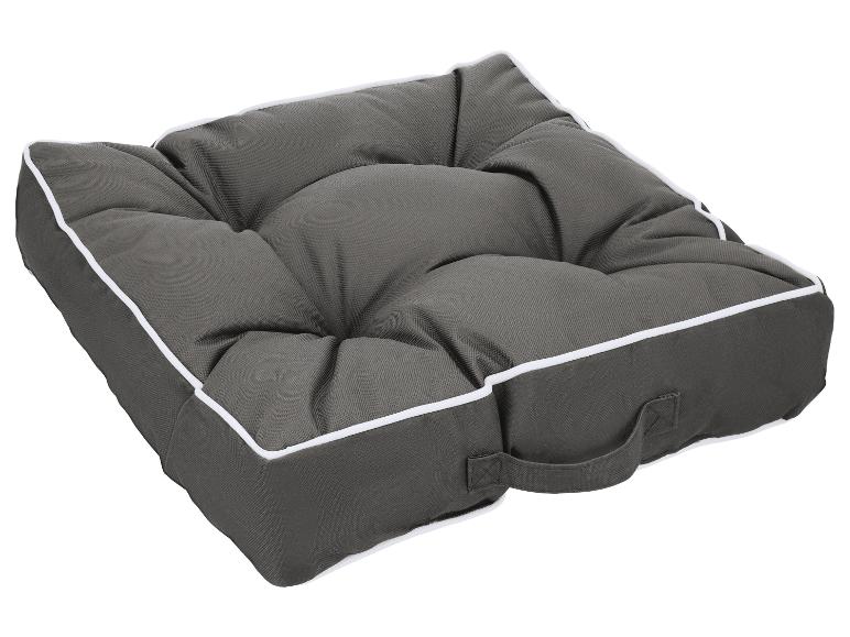 Coussin de siège capitonné gris foncé avec passepoil blanc et poignée de transport.