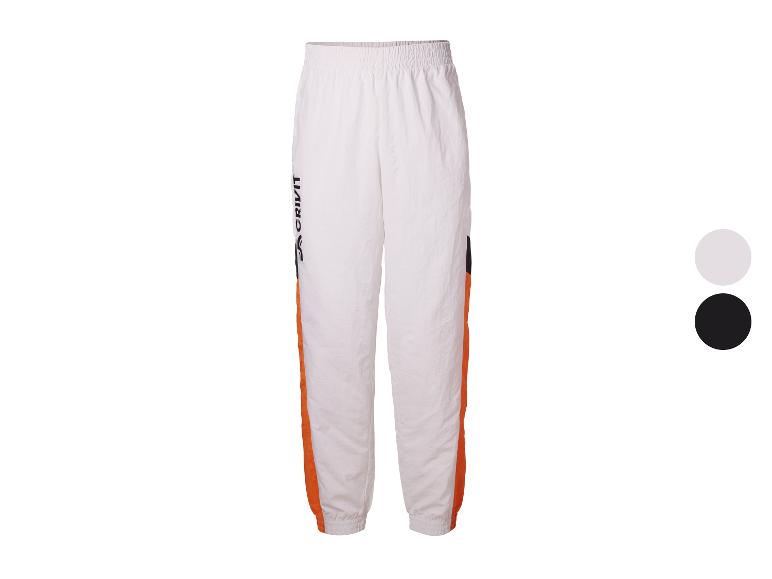 Pantalon de survêtement blanc avec bandes orange et noires