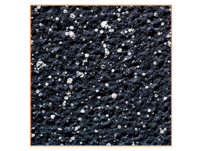 Gros plan d'une surface sombre et texturée avec de petites taches brillantes