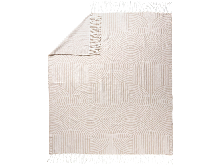 Plaid beige à motif géométrique de cercles et losanges, avec franges.
