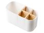 Un organiseur blanc pour couverts avec des inserts en bois.