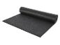 Un tapis de yoga noir roulé de la marque 