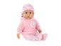 Poupée bébé en tenue rose avec motifs de cœurs et de roses