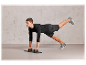 Homme en vêtements de sport noirs faisant des pompes sur une planche à pompes.