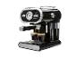 Machine à expresso noire avec des détails chromés, préparant deux cafés dans des tasses en verre.