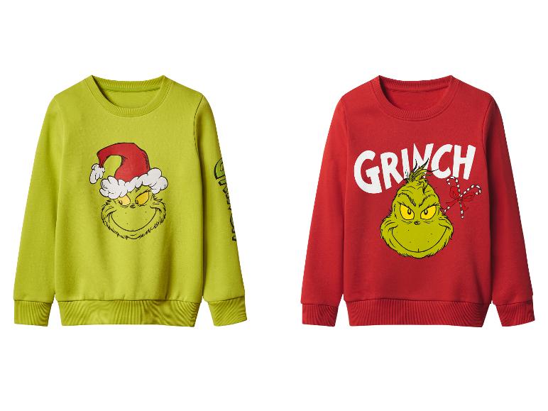 Deux pulls Grinch, un vert et un rouge, avec des imprimés de Noël.
